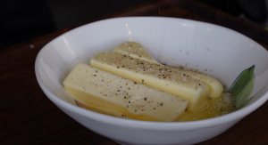 Three sticks of butter being seasoned for turkey preparation