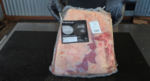 Chef holding a packaged USDA Prime short ribs ready for preparation.