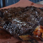Finished smoked beef short ribs resting on butcher paper