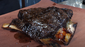 Finished smoked beef short ribs resting on butcher paper