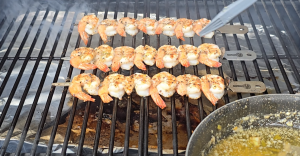 Shrimp skewers grilling on a Z Grills with garlic butter basting